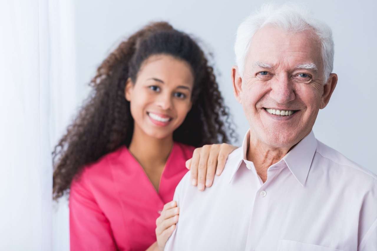Team Member and Happy Resident at the Preserve at Dunedin, an ECC-Licensed Community - The Preserve An older man with a caring team member at The Preserve, a senior living community in Clearwater, Florida.
